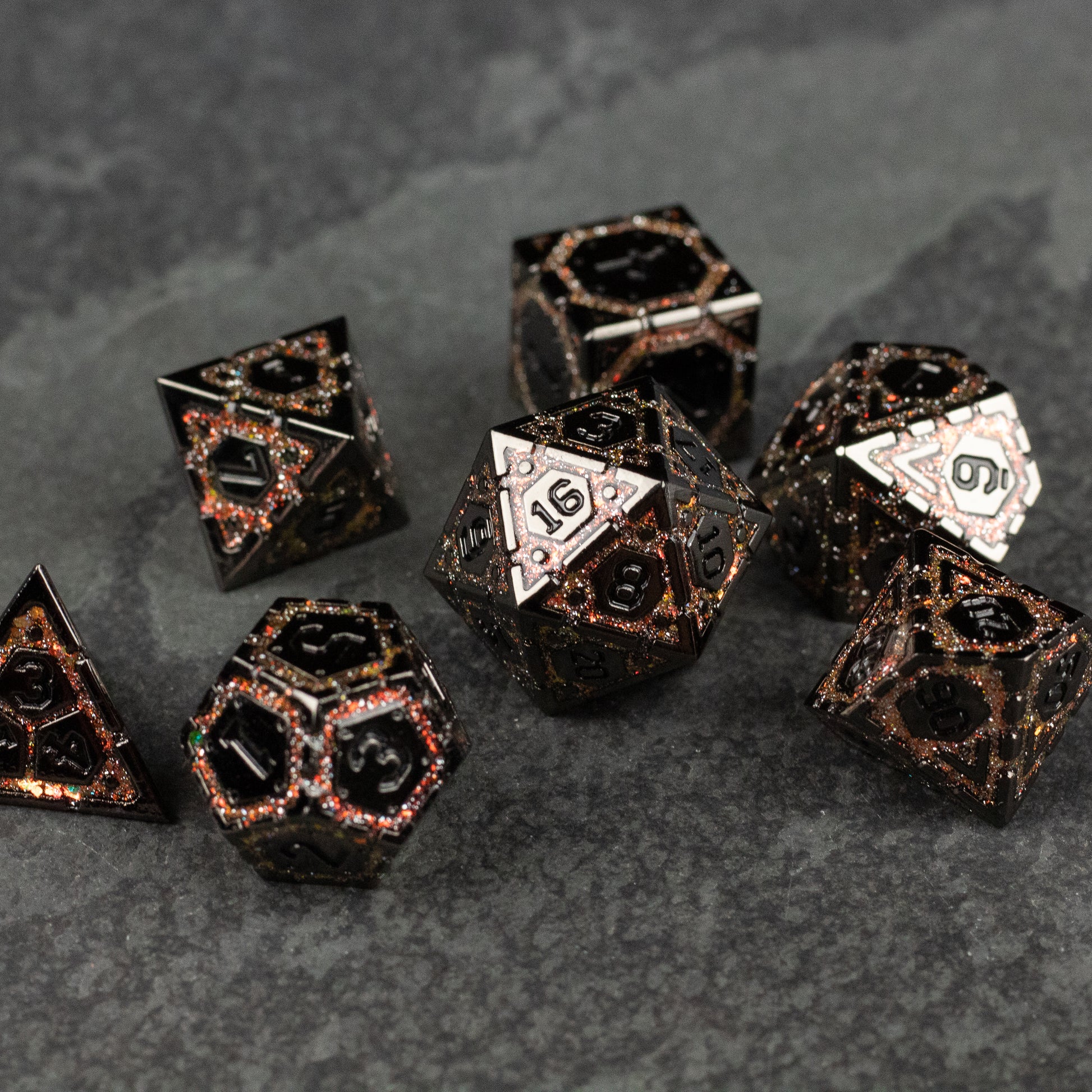 Gold Arcane Ward Metal Dice Set - Black metal dice set with gold arcane symbols and numbers, featuring various polyhedral shapes.