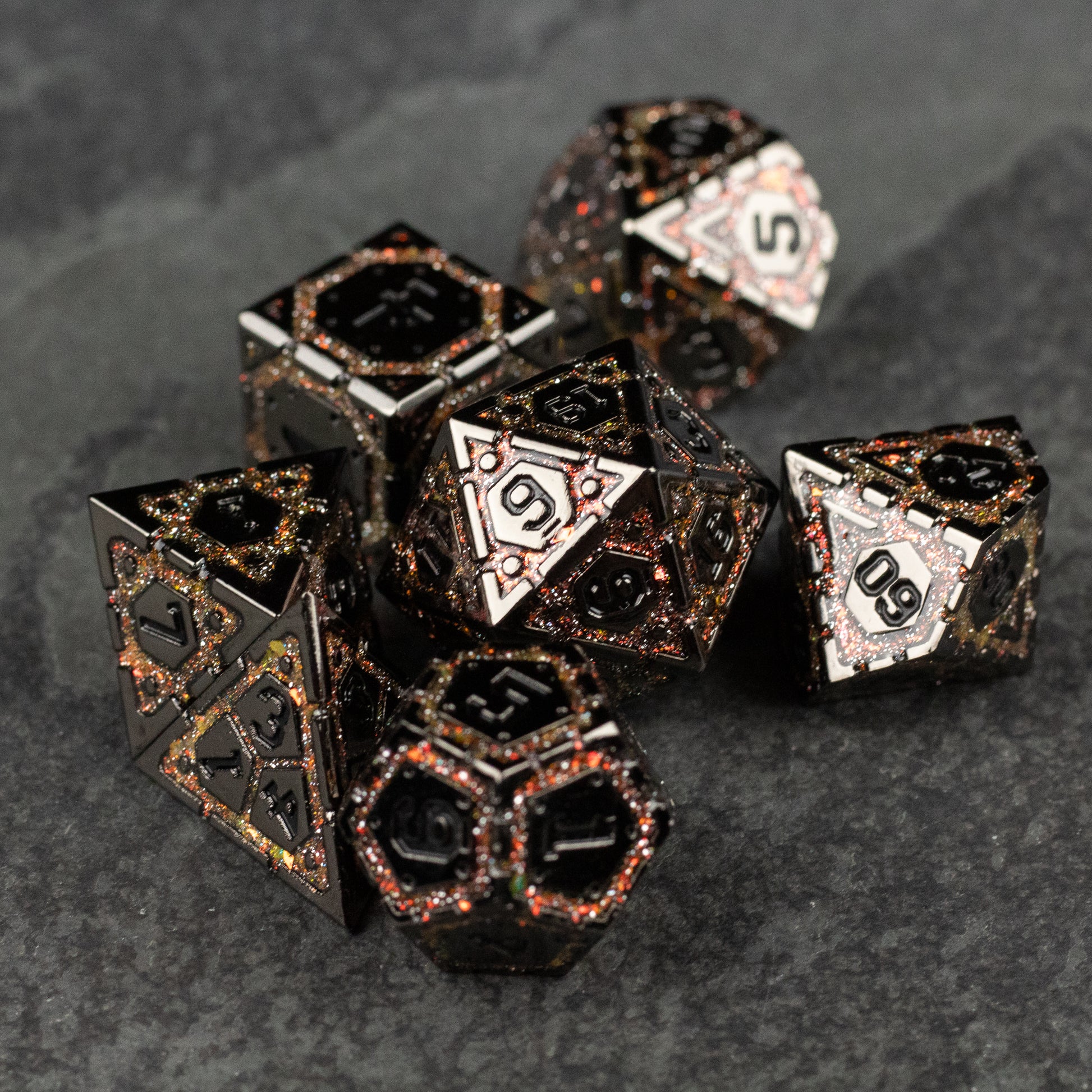 Gold Arcane Ward Metal Dice Set - Black metal polyhedral dice set with gold filigree detailing and white numbered faces.