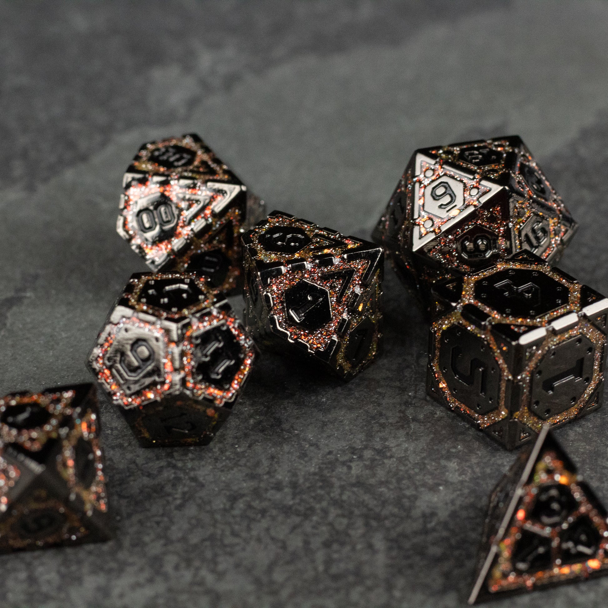 Gold Arcane Ward Metal Dice Set - Set of black metal polyhedral dice with gold arcane-inspired geometric patterns and white numbering on each face.