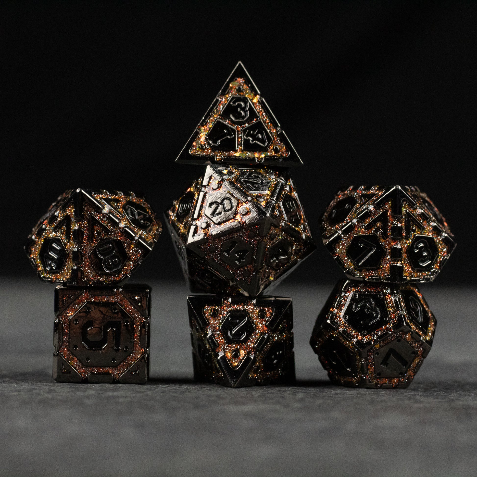 Gold Arcane Ward Metal Dice Set - Set of seven gold and black metal polyhedral dice with arcane symbols and numbers, including d20, d12, d10, d8, d6, and d4.