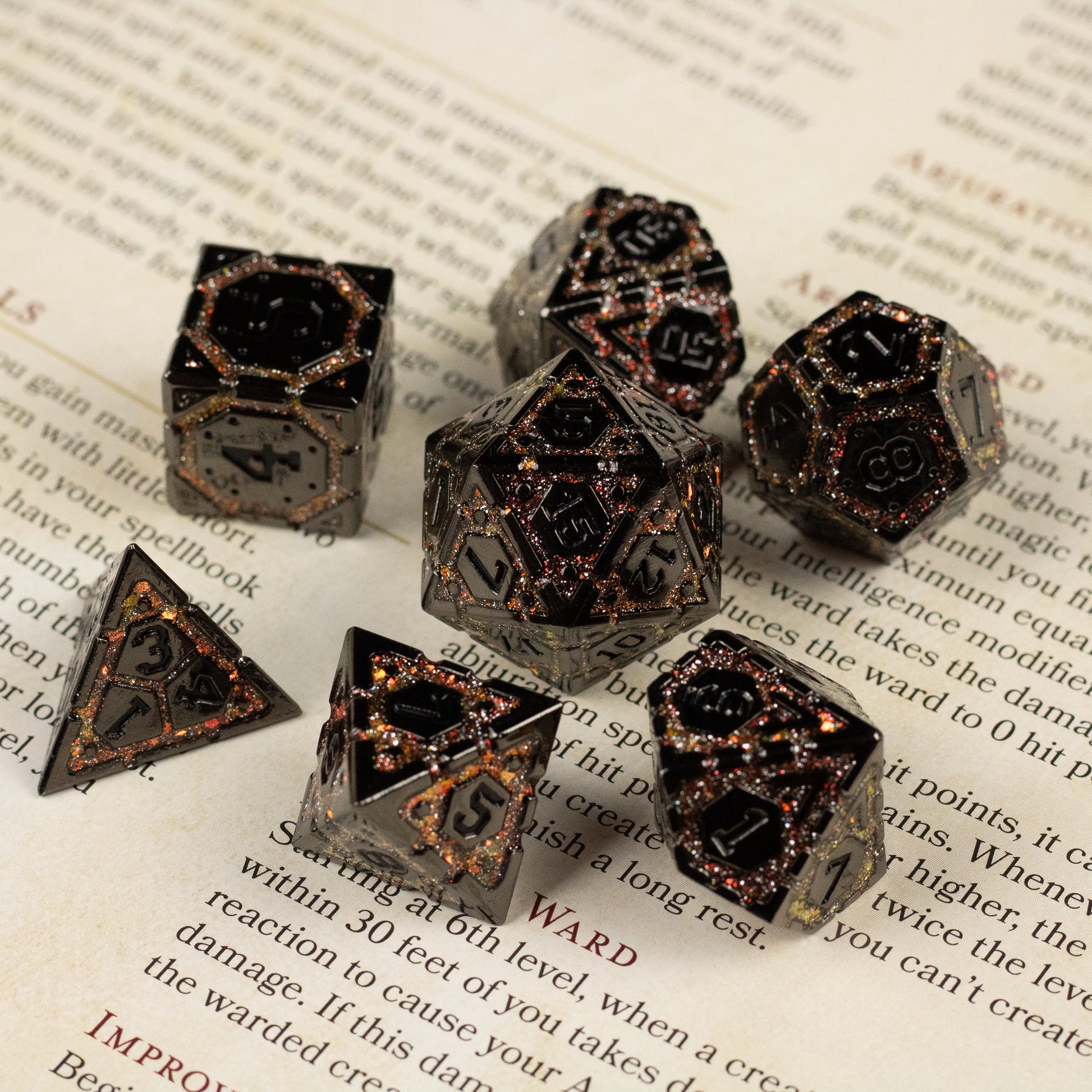 Gold Arcane Ward Metal Dice Set - Seven black and gold metal polyhedral dice with intricate arcane designs and glowing gold numbering.