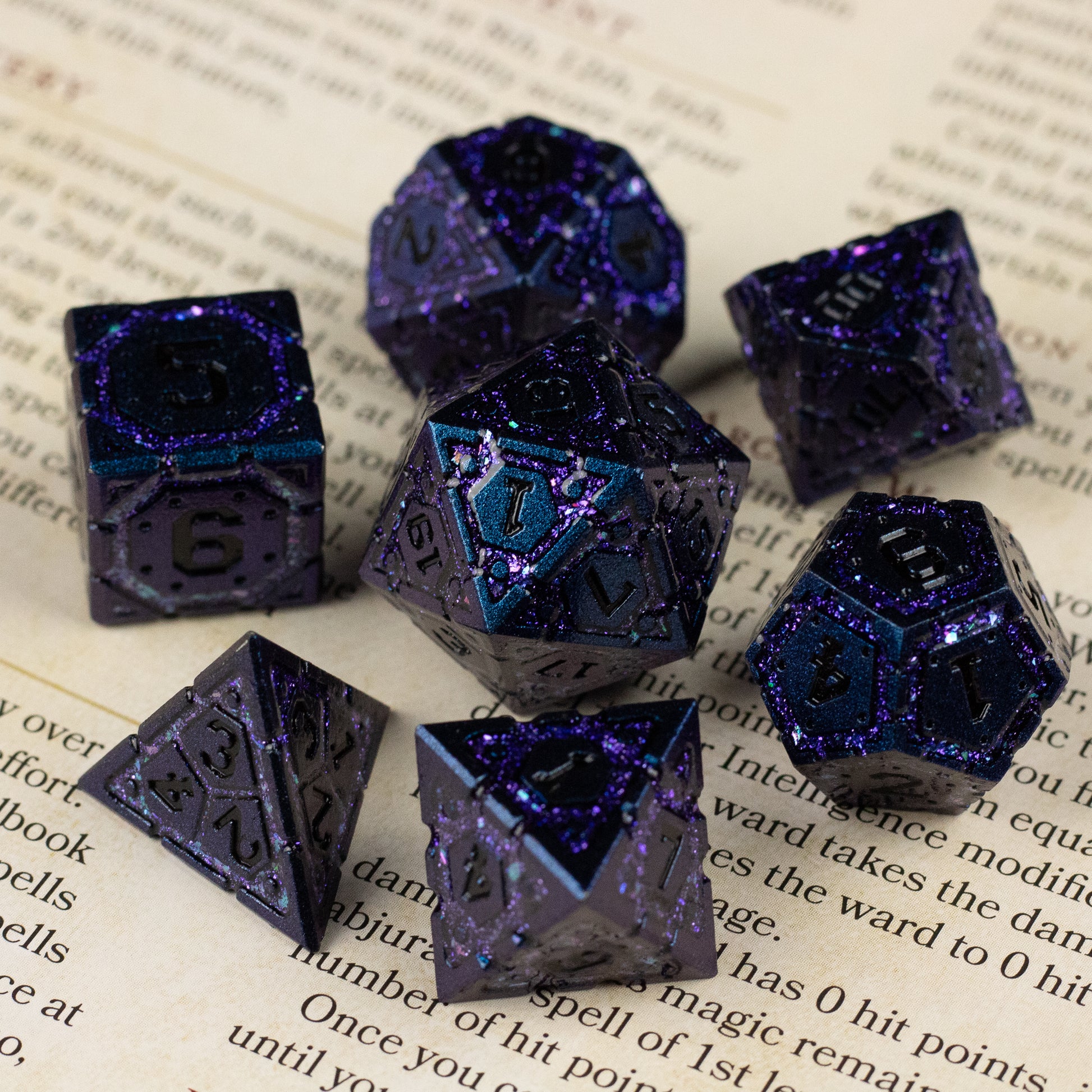 Purple Superior Ward Metal Dice Set - Set of seven purple metal polyhedral dice with a metallic finish and bright blue edges on a printed background.