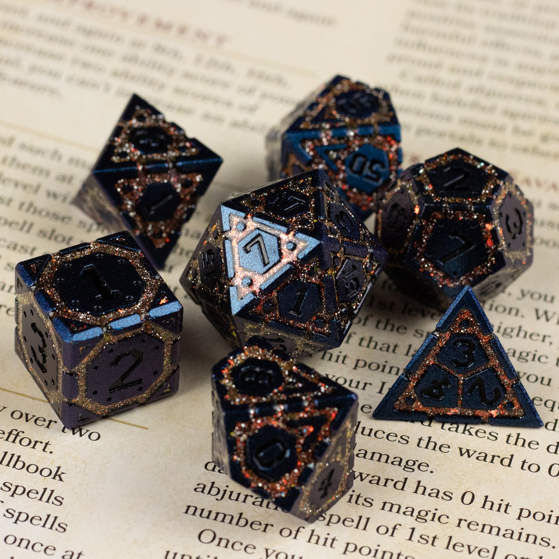 Gold Superior Ward Metal Dice Set - Set of six black metal polyhedral dice with gold veining and white numbering, including d4, d6, d8, d10, d12, and d20 shapes.