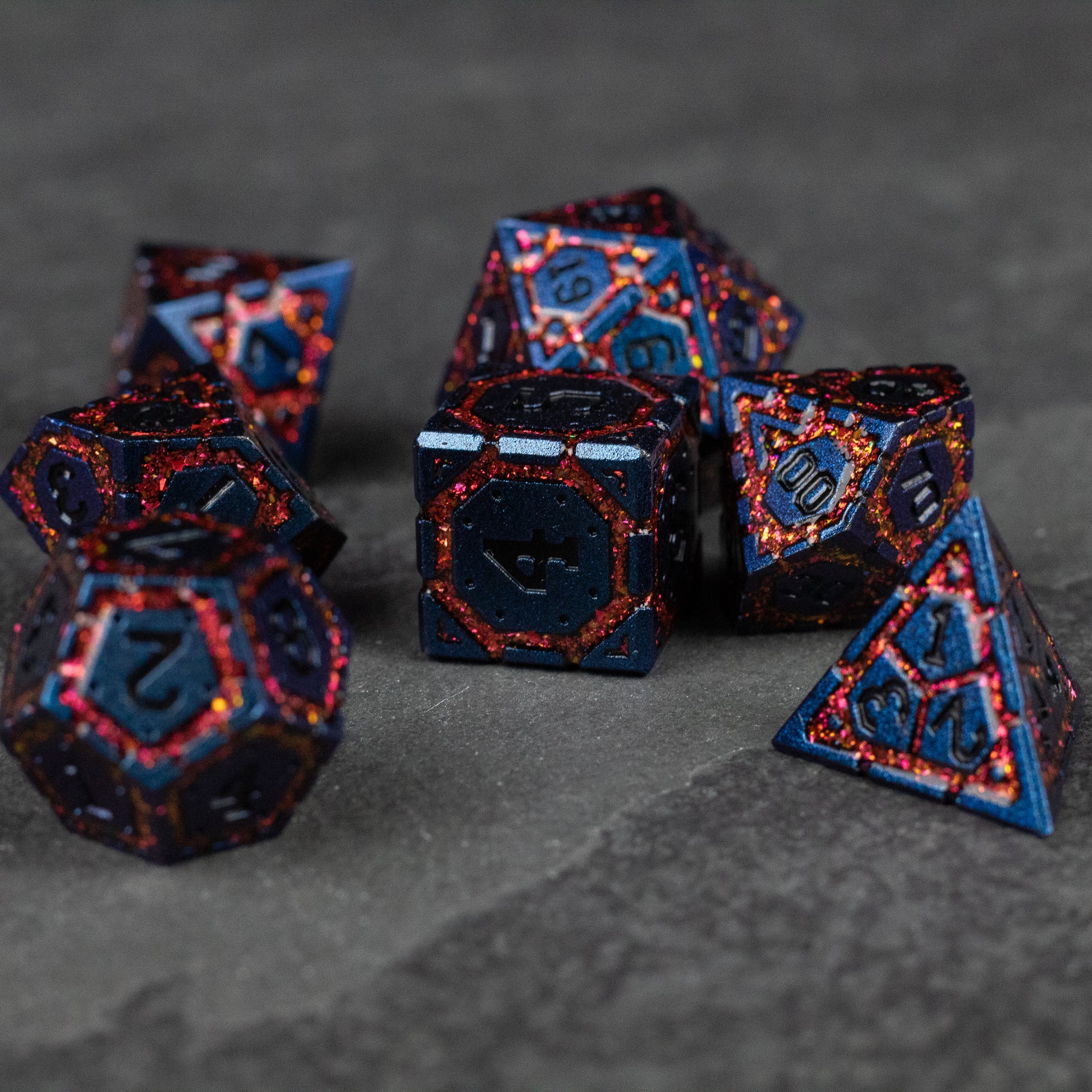 Red Superior Ward Metal Dice Set - Set of red metallic polyhedral dice with glowing blue numbers and intricate glowing edge details.