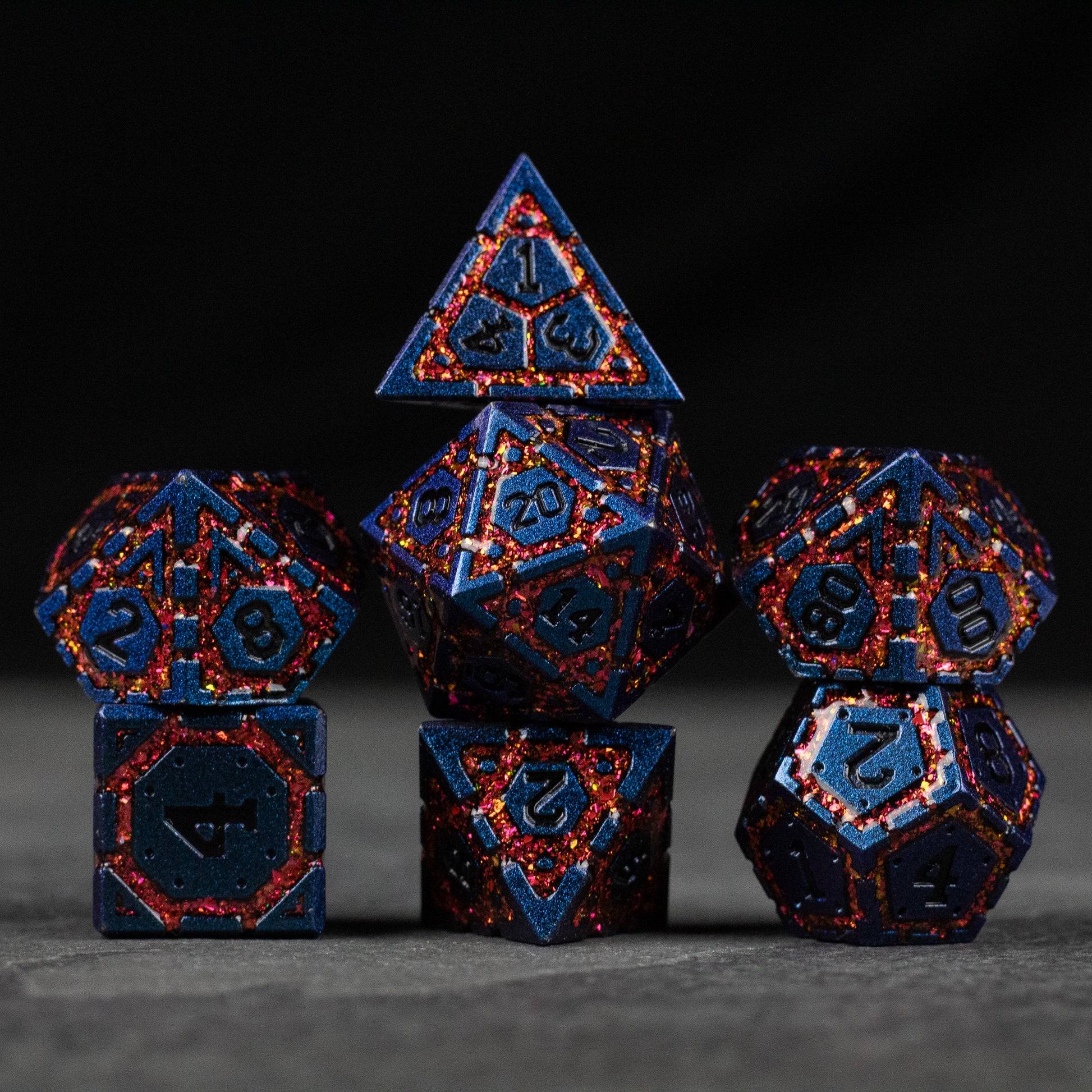 Red Superior Ward Metal Dice Set - Set of dark blue metal dice with red vein-like accents and engraved numbers, including d4, d6, d8, d10, d12, and d20 shapes.