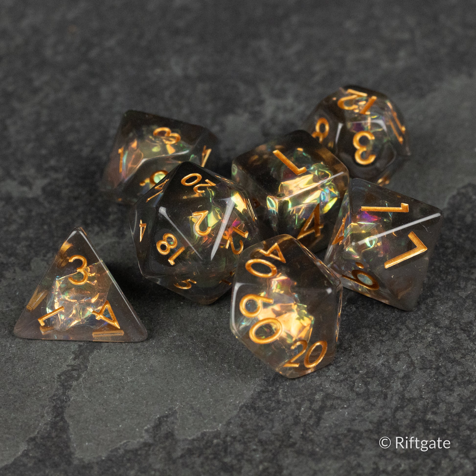 Dark Star Dice Set - Black translucent polyhedral dice set with gold numbering and iridescent shimmer.