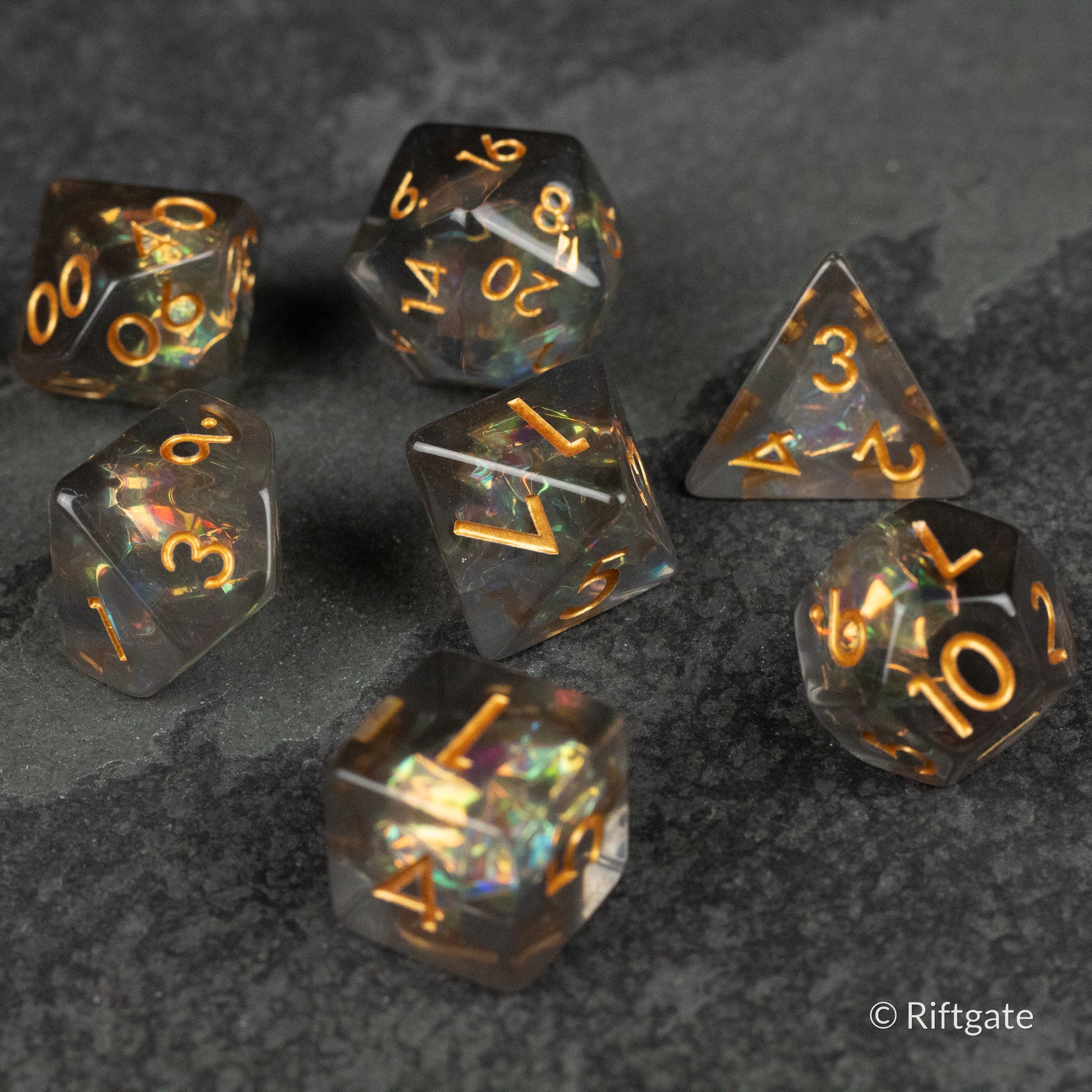 Dark Star Dice Set - Seven dark translucent polyhedral dice with gold numbering, including d4, d6, d8, d10, d12, d20, and percentile dice.