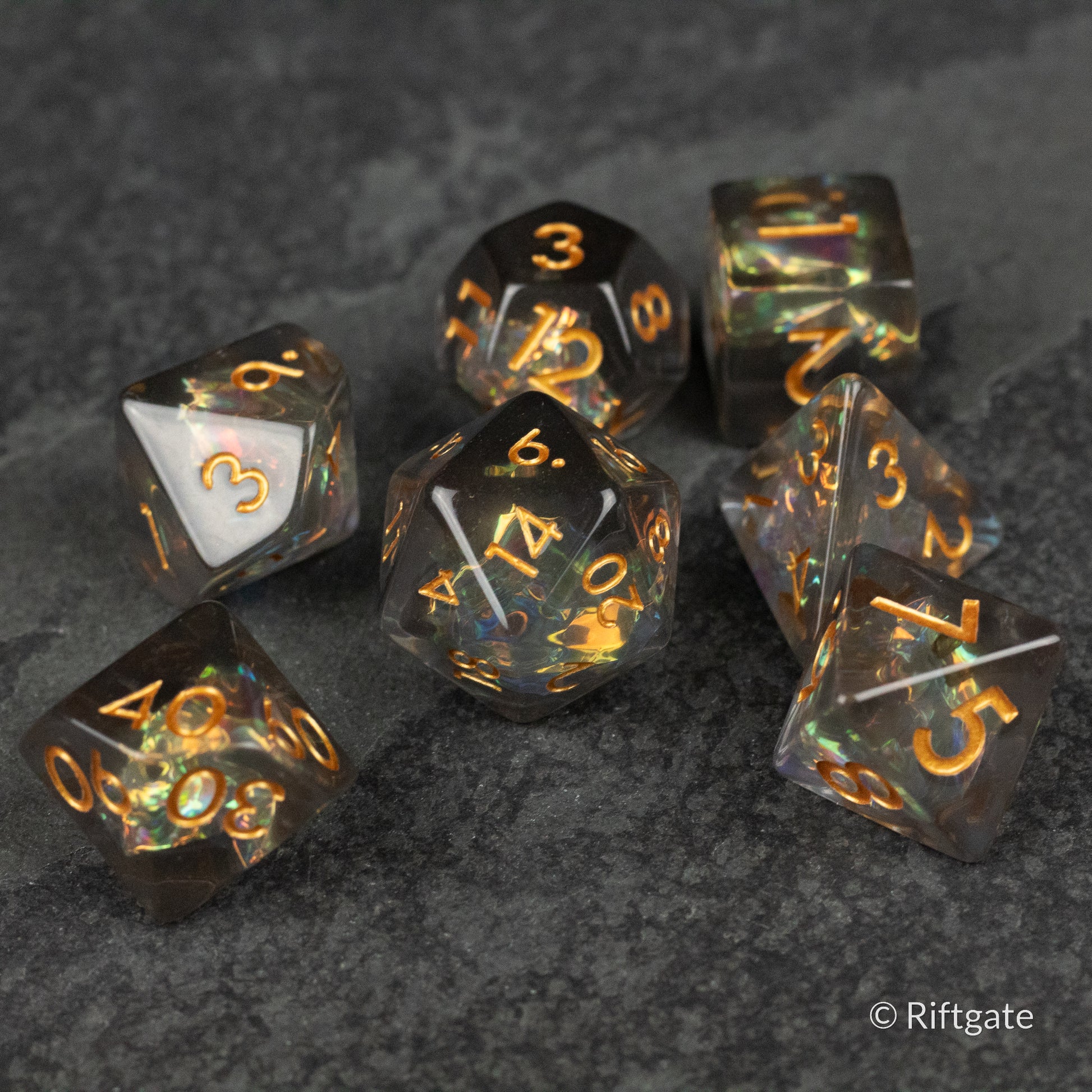 Dark Star Dice Set - Seven-piece black and dark green marbled polyhedral dice set with orange numbering.