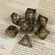 Dark Star Dice Set - Glossy black polyhedral dice set with shimmering gold numbers, including d20, d12, d10, d8, d6, and d4 designs.