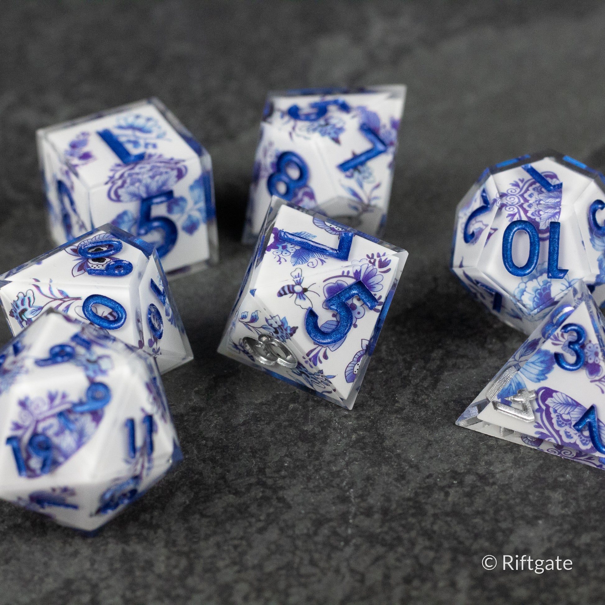 Moonlight Garden Dice Set - White polyhedral dice set with intricate blue floral and moon designs on each face.