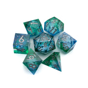 Triton's Treasure Liquid Core Dice Set - Seven translucent polyhedral dice with a swirling green and blue liquid core and white numbering.
