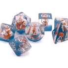 Brown Cat Inclusion Dice: Round edge dice with a brown cat set inside standing on blue sand. The numbers are white. Angle is from behind