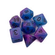 Emberlight Nocturne Glow-in-the-Dark Dice Set - Set of seven purple and blue glow-in-the-dark polyhedral dice with black numbering for tabletop gaming.