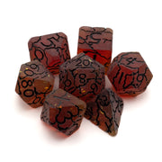 Molten Cracked Slag Dice Set - Set of seven translucent red dice with black crack-like patterns and gold numbers, including a d20, d12, d10, d8, d6, and d4.