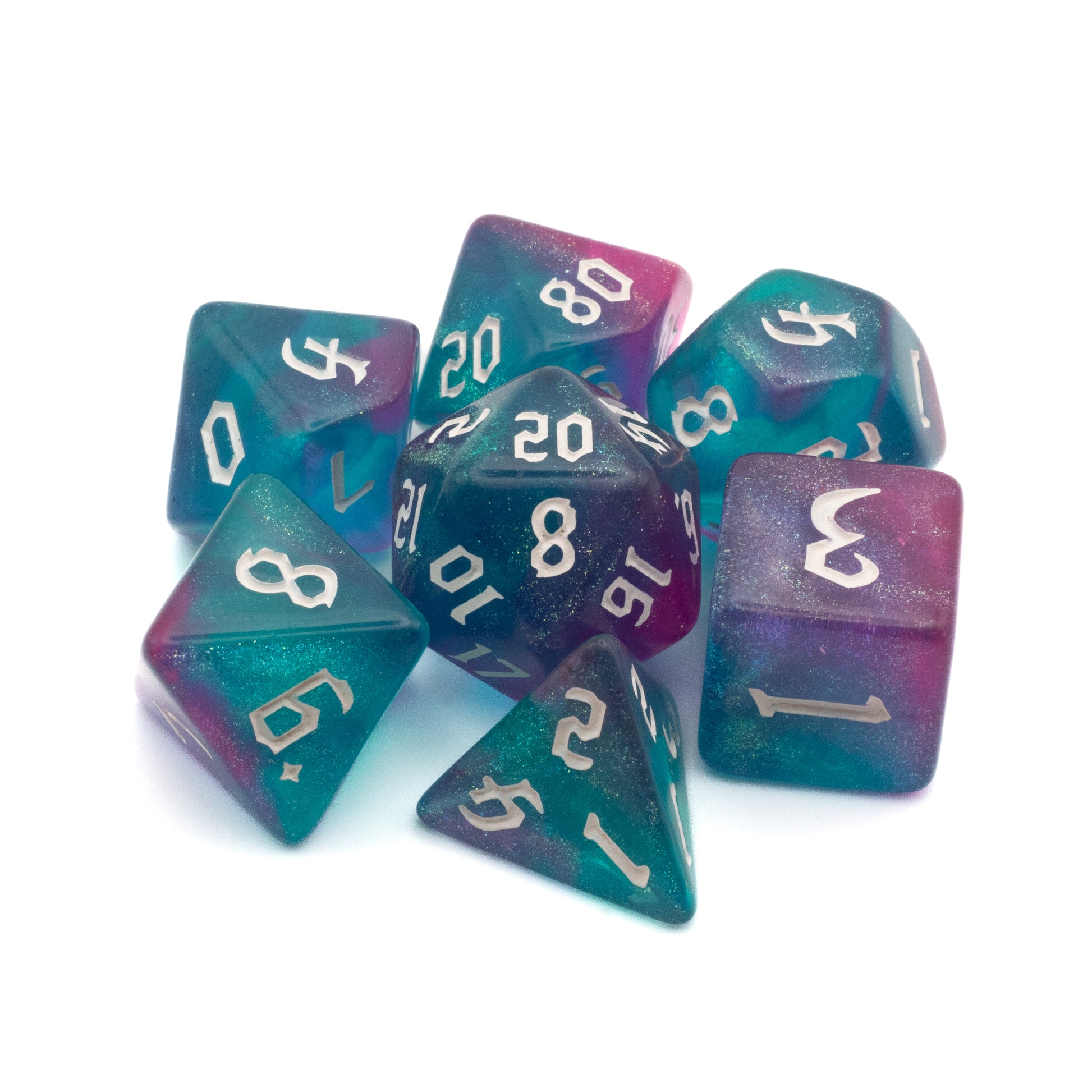 Pink & Teal Glitter Dice Set - Seven polyhedral dice in pink and teal glitter with white numbering, including d20, d12, d10, d8, d6, and d4 shapes.