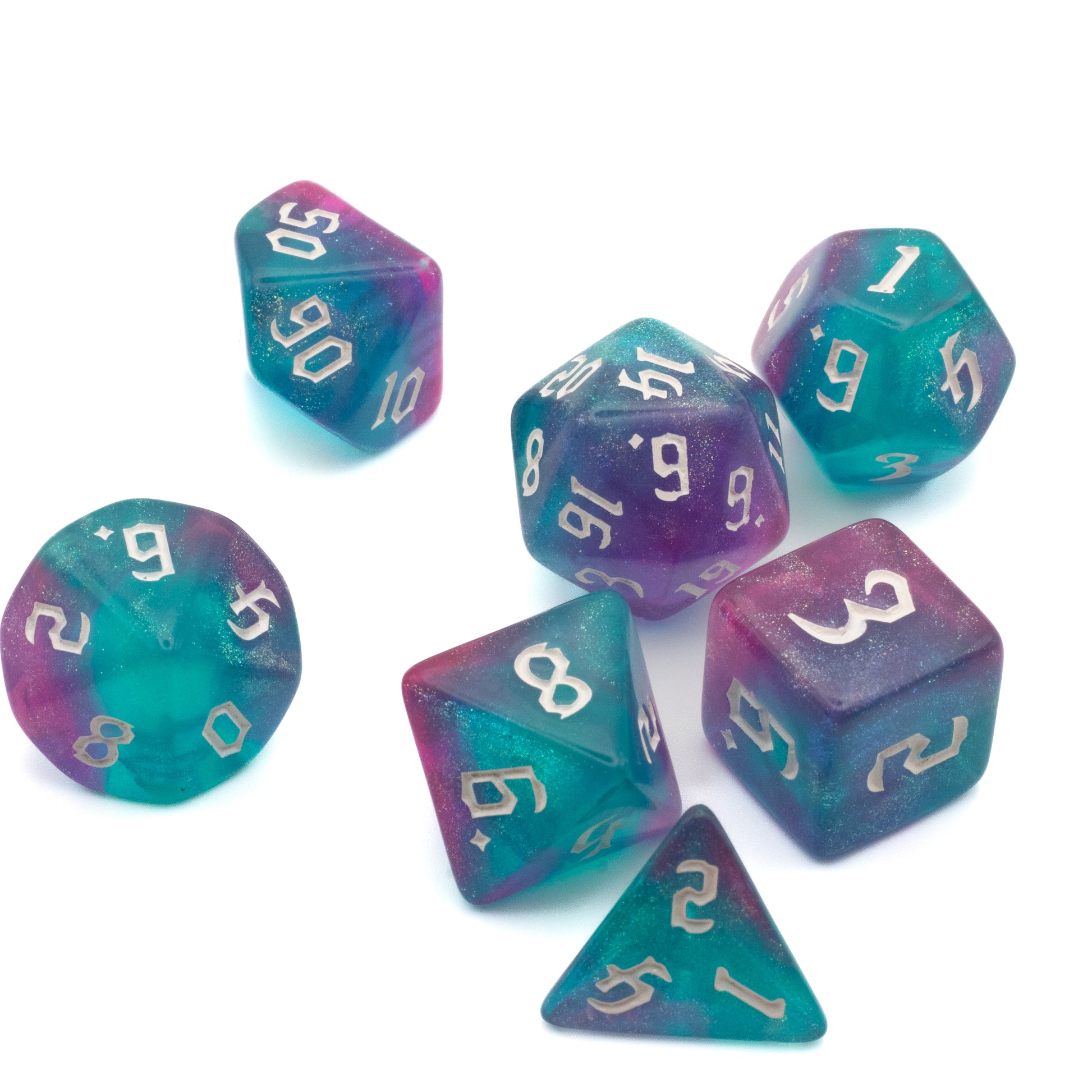 Pink & Teal Glitter Dice Set - Set of seven multifaceted dice in translucent pink and teal with silver numbers, featuring various shapes including a d20,.