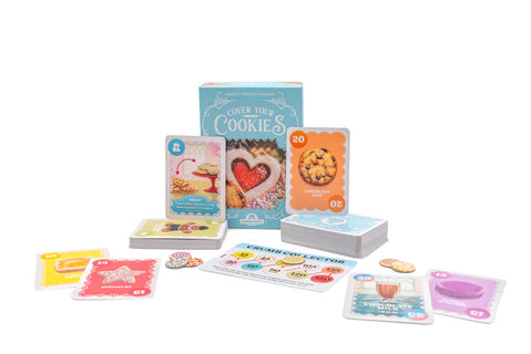 Cover Your Cookies - Colorful playing cards featuring cartoon cookies and dessert-themed illustrations laid out with a light blue game box titled