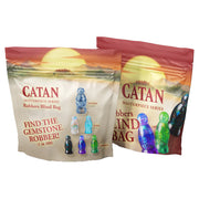 Catan Masterpiece Series: Premium Resin Robber Blind Bag (PREORDER) - Two Catan Masterpiece Series premium resin robber blind bags with sunset background and colored robber figurine.