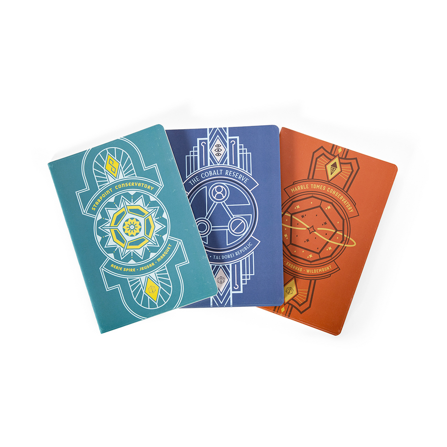 Critical Role Libraries of Exandria Notebooks 3-Pack - Three hardcover notebooks in teal, navy, and burnt orange with intricate geometric fantasy designs on the covers.