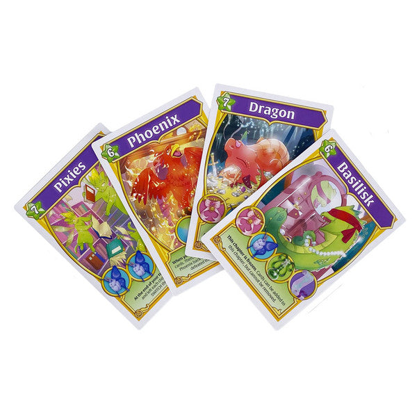 Wizard Kittens: Library Edition - Four colorful fantasy-themed playing cards titled Pixies, Phoenix, Dragon, and Basilisk with detailed creature illustrations