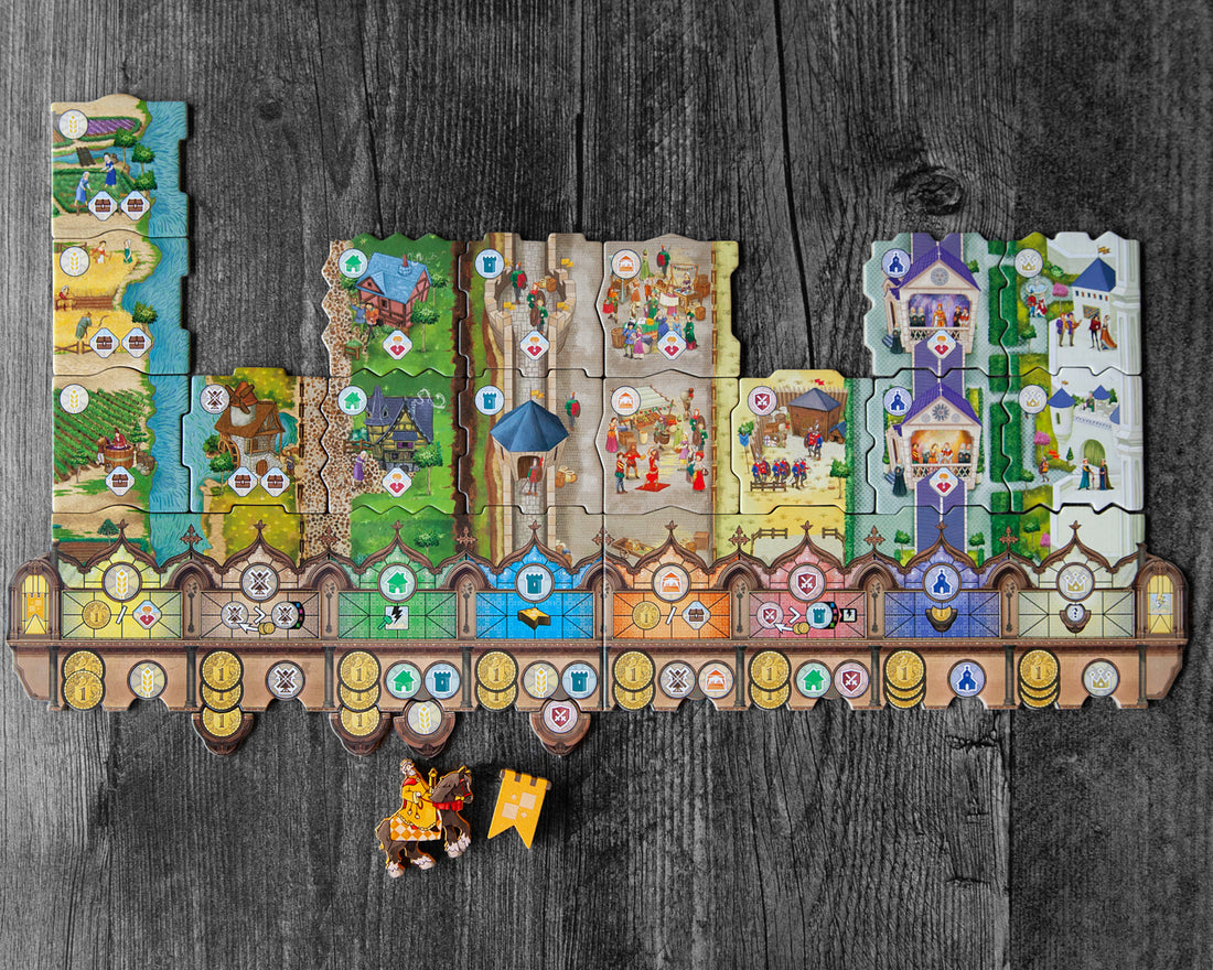 Middle-Ages - Colorful, intricately detailed medieval-themed game board with castle, village, and farmland tiles arranged in a row on dark