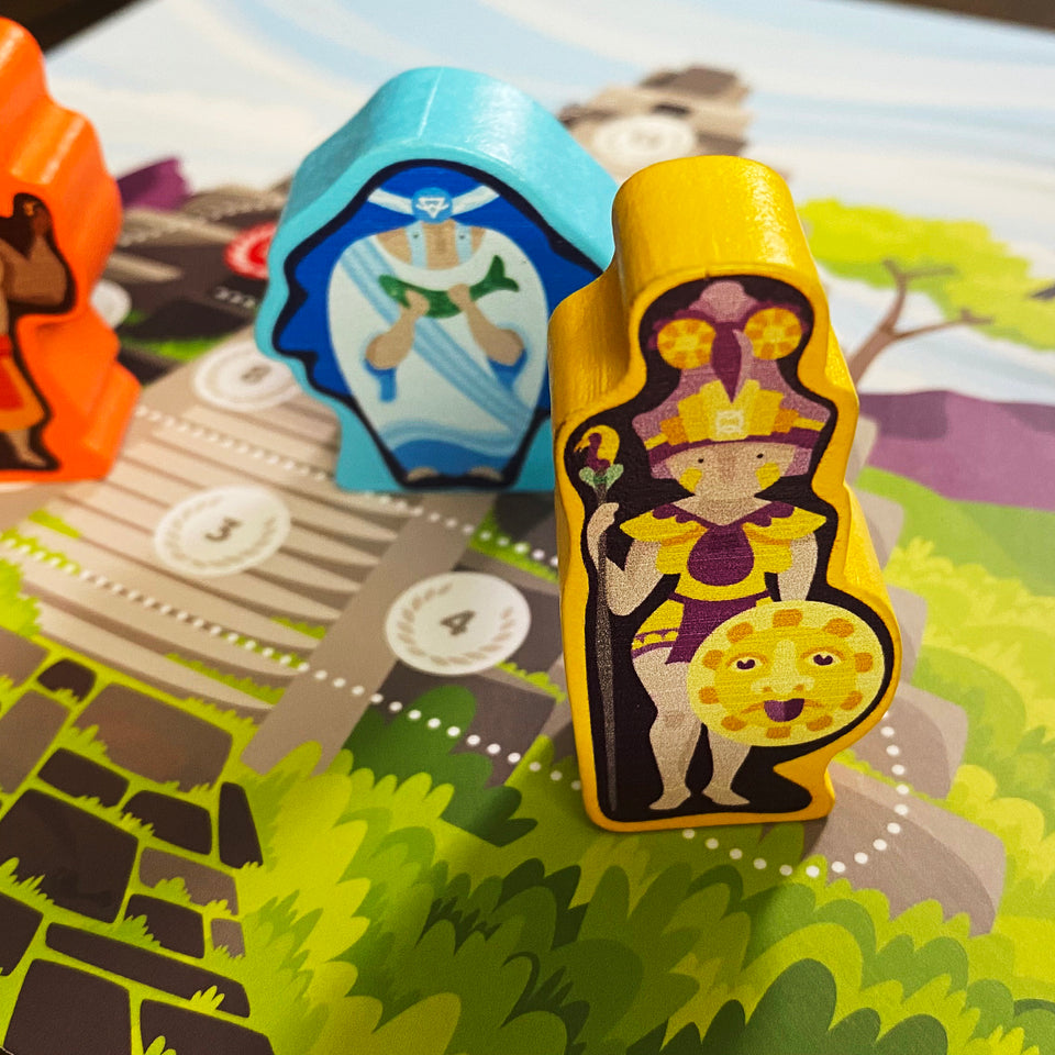 Oros Collector's Edition - Yellow and blue wooden game pieces with illustrated characters on a colorful strategy game board.
