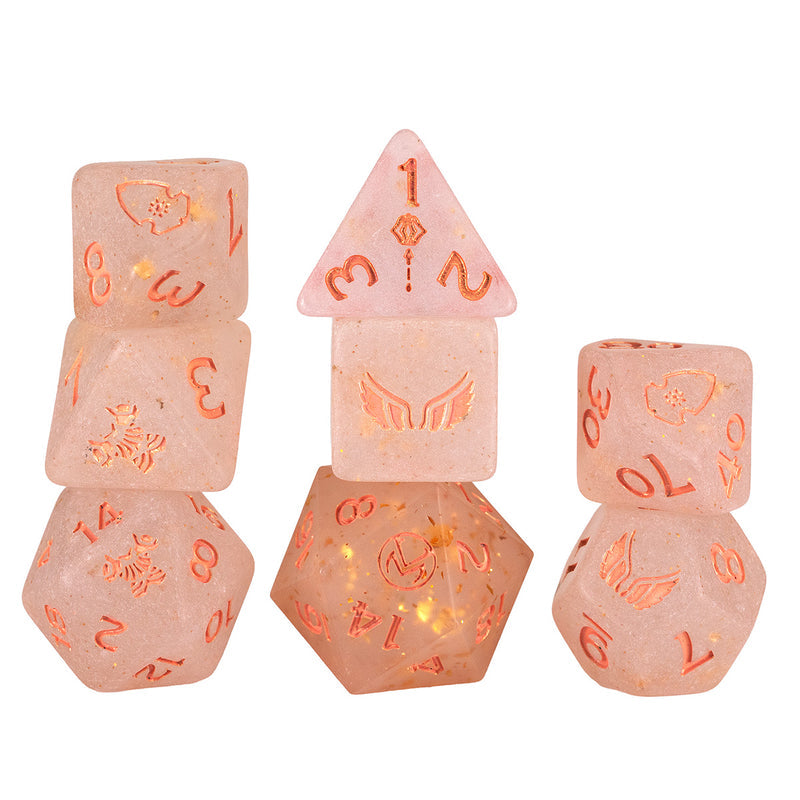 Sirius Dice: Vox Machina Adventure Dice - Pike Trickfoot (PREORDER) - Six dusty pink polyhedral dice with glowing orange numbers and intricate symbols, including wings and mystical icons.