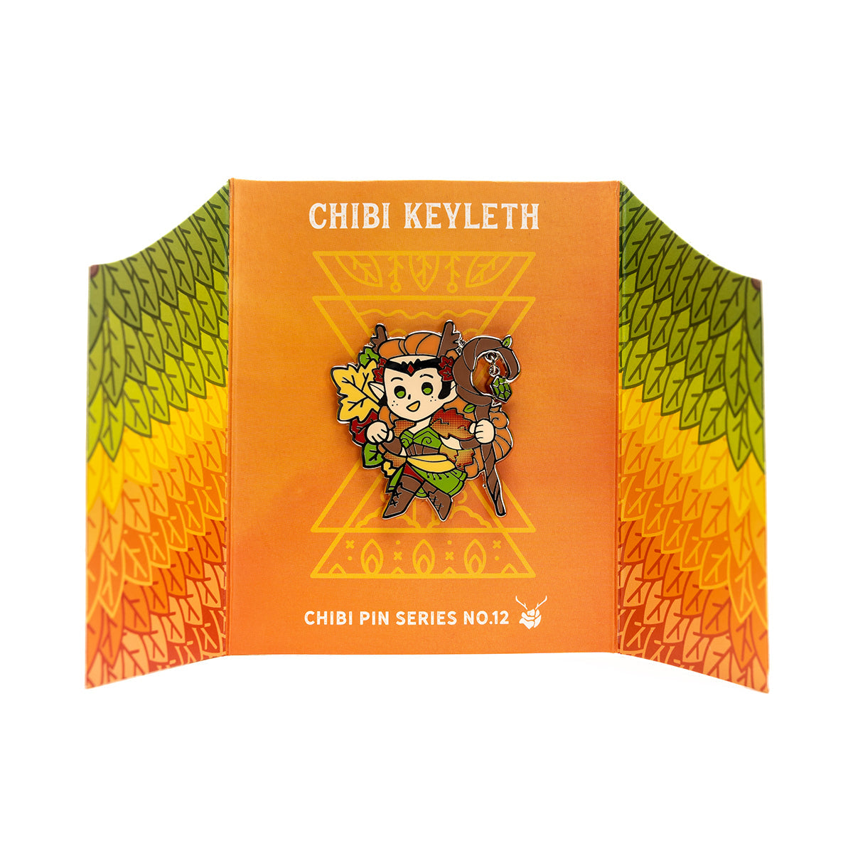 Critical Role Chibi Pin - Keyleth - Chibi-style enamel pin of Keyleth with green leafy cloak, brown hair, and wooden staff on orange backing card with yellow.