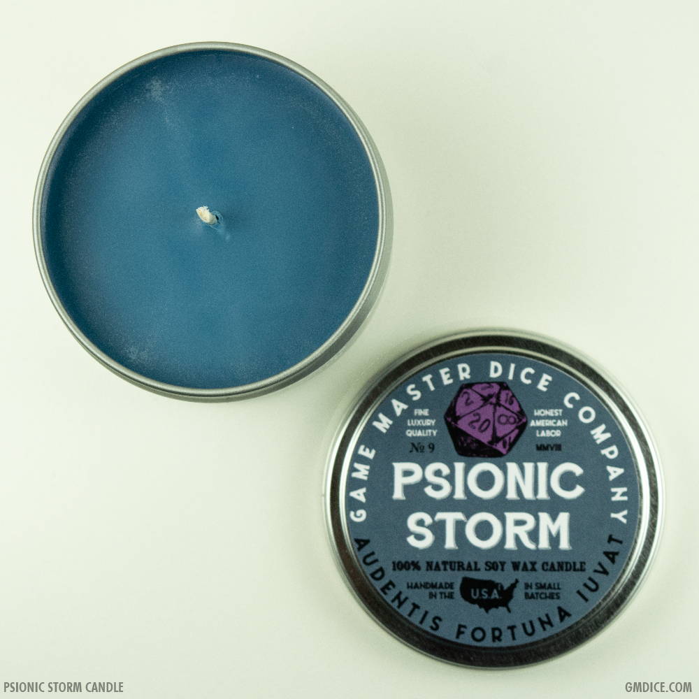 Psionic Storm Gaming Candle - Blue wax candle in a round silver tin with Psionic Storm label featuring a purple 20-sided die design.