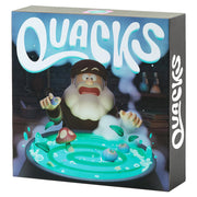 Quacks - Board game box with a cartoon wizard and blue magical swirling path featuring mushrooms and colorful game pieces.