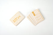 Obojima RPG Potion Recipe Cards (PREORDER) - Beige RPG potion recipe cards with grid layout and vintage-style text, arranged fanned out and stacked.