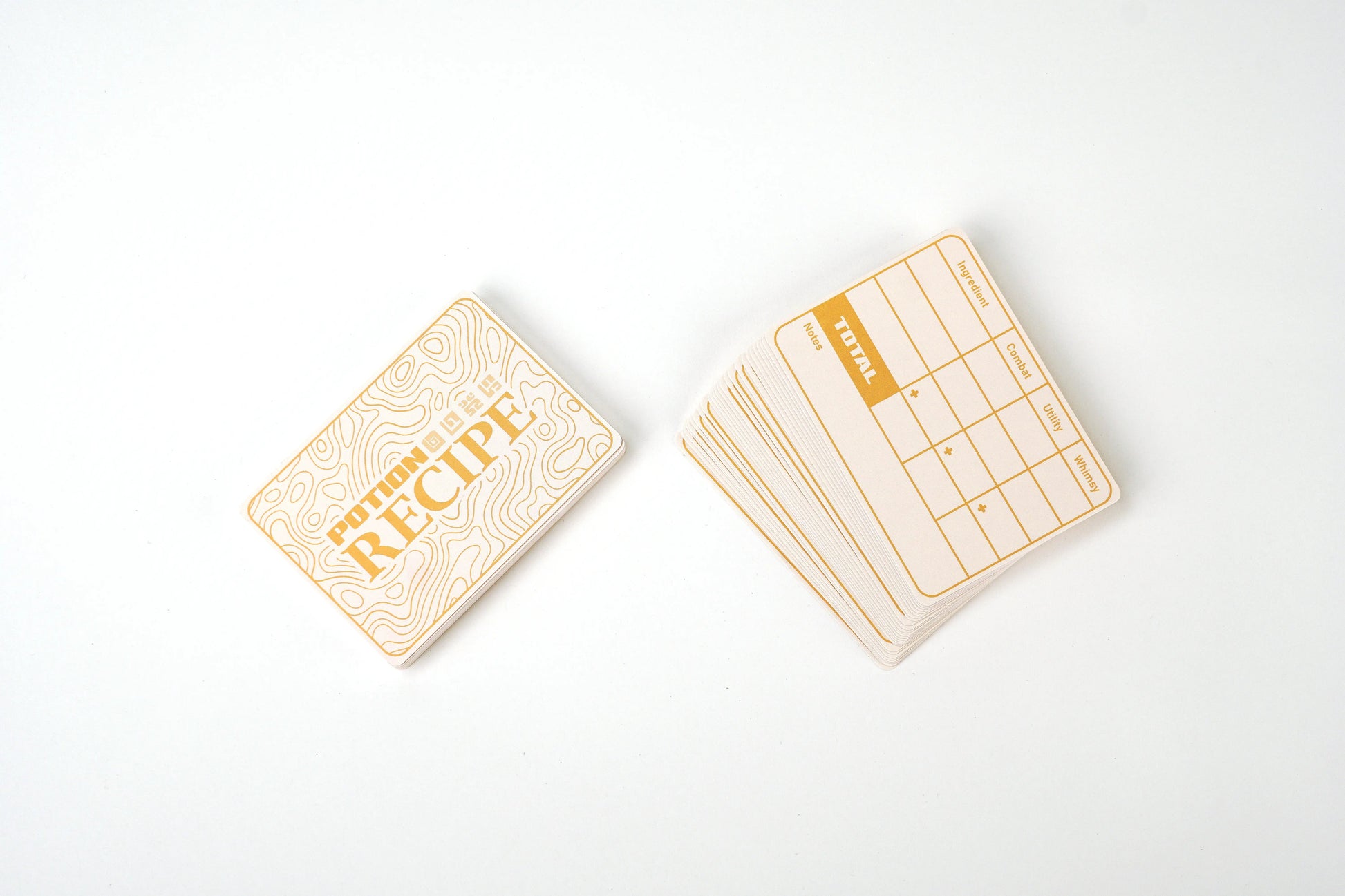 Obojima RPG Potion Recipe Cards (PREORDER) - Beige RPG potion recipe cards with grid layout and vintage-style text, arranged fanned out and stacked.