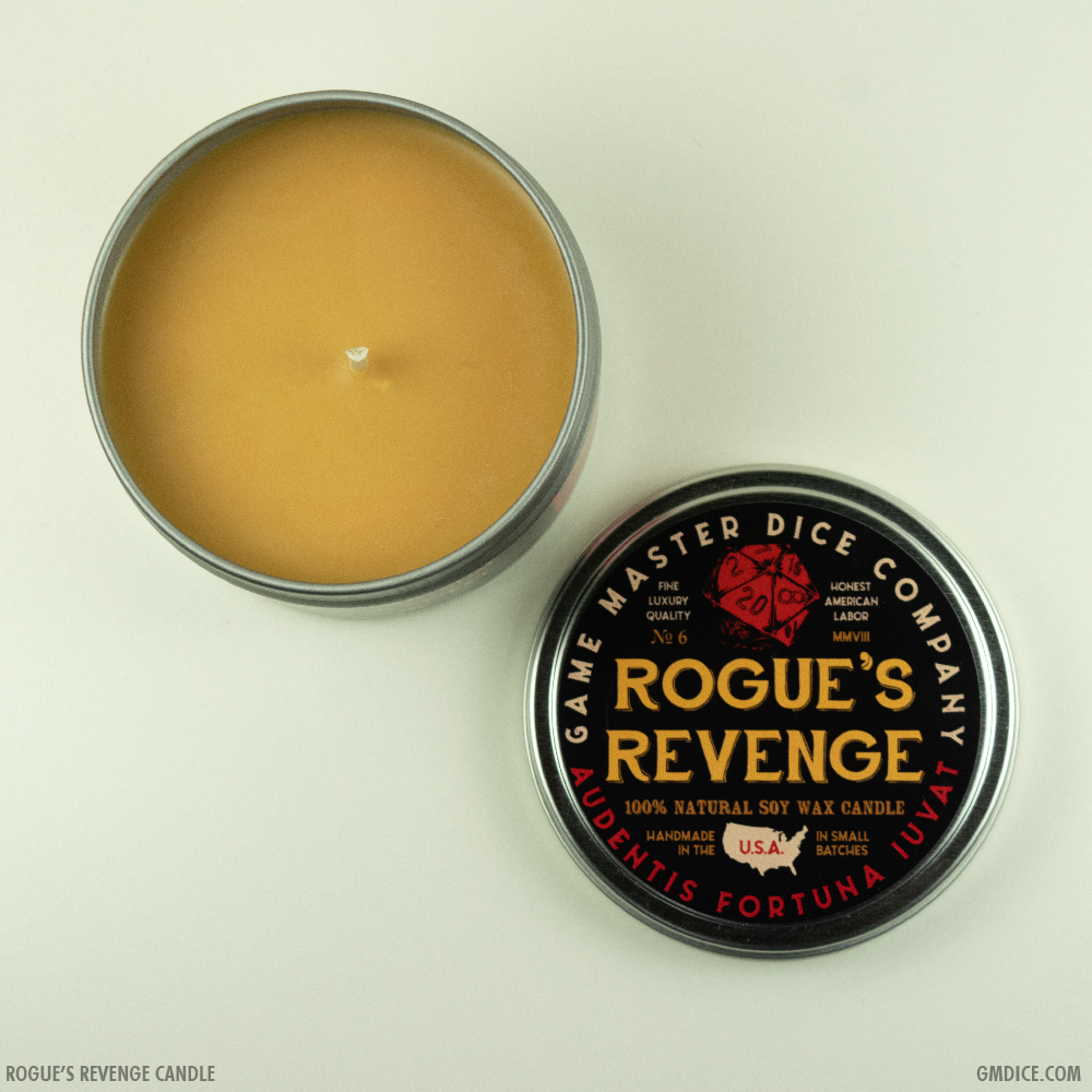 Rogue's Revenge Gaming Candle - Round silver tin candle with smooth golden wax and black lid labeled Rogue's Revenge from Game Master Dice Company.
