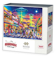 Boardwalk 500 Piece Puzzle: Roswell - Colorful 500-piece puzzle box featuring a vibrant retro street scene with UFOs over Roswell at sunset.