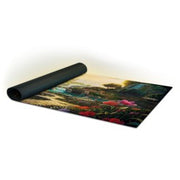 Sorcery: Contested Realm - Arthurian Legends Playmat - Valley of Delight - Rolled black gaming playmat featuring a colorful Arthurian-themed fantasy landscape with lush greenery and vibrant flowers.