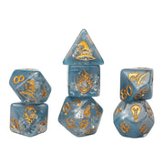 Sirius Dice Stranger Things Adventure Dice - Will - Six translucent blue polyhedral dice with gold Stranger Things-themed engravings including a ship, crab, lightbulb, flame,.