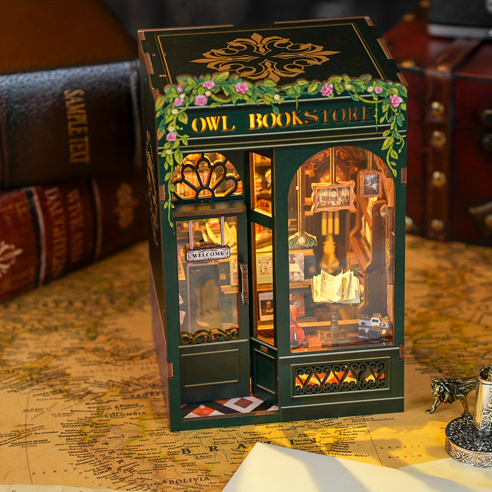 Owl Bookstore Book Nook (PREORDER) - Miniature dark green wooden bookstore model with gold floral details and "Owl Bookstore" sign, displaying tiny books and a.