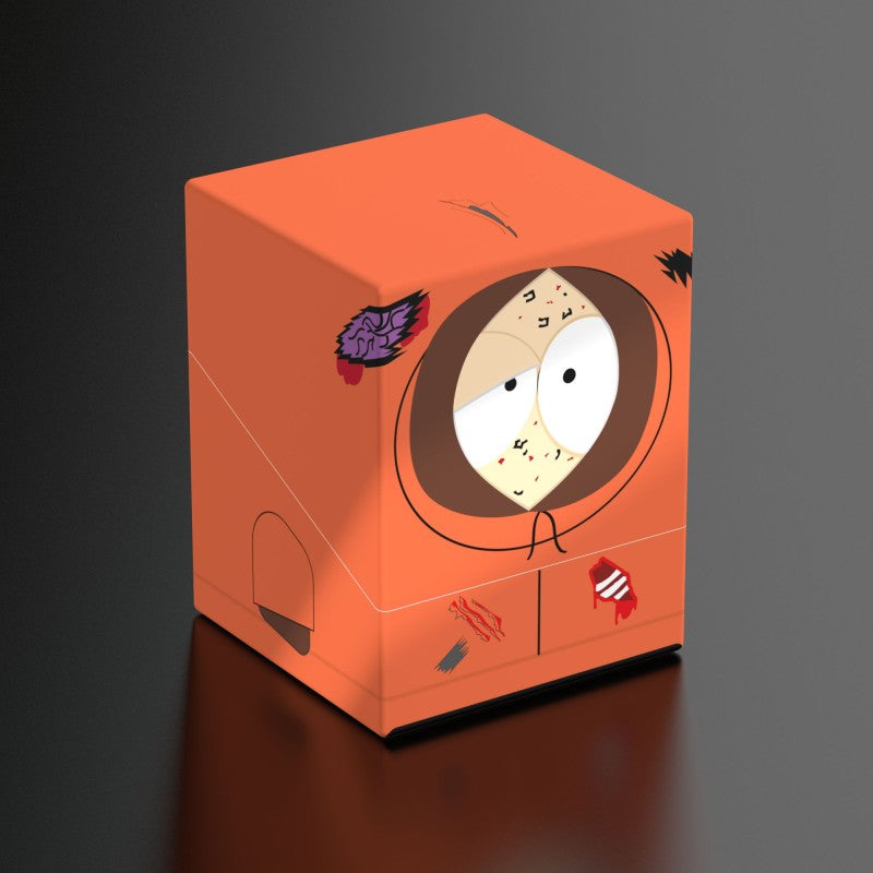 Squaroes: 100+ Deckbox - South Park - Dead Kenny - Orange rectangular deck box featuring Dead Kenny character design with cartoon eyes and hood details.