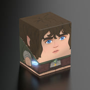 Squaroes Boulder 100+: The Lord of the Rings - Frodo - Brown cube-shaped deck box featuring a stylized cartoon face of Frodo with blue eyes and curly dark hair.
