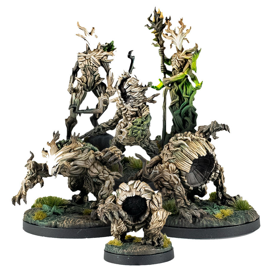 Epic Encounters: Forest Of The Damned (PREORDER) - Set of five detailed tree-like miniatures with bark textures, leafy crowns, and twisted limbs on round bases with grass.