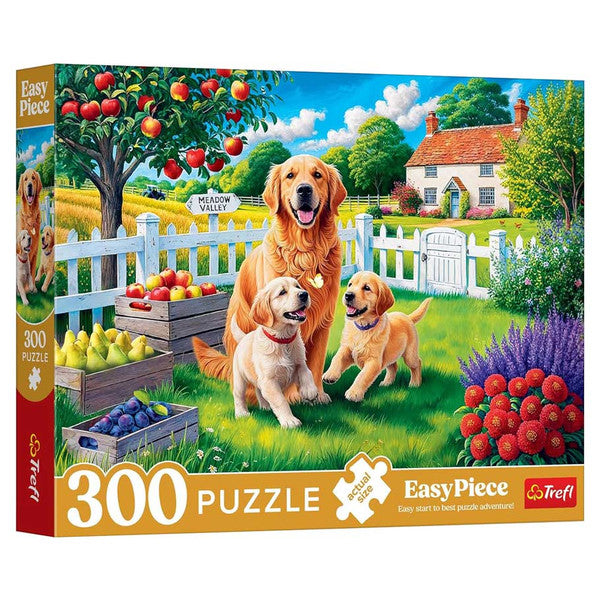 Puzzle: Dogs in the Countryside 300 Piece - Colorful 300-piece puzzle box featuring playful dogs in a vibrant countryside garden with apple trees and a cottage.