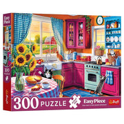 Puzzle: Morning in the Kitchen 300 Piece - Colorful 300-piece kitchen puzzle with bright red cabinets, sunflower vase, and blue checkered curtains.