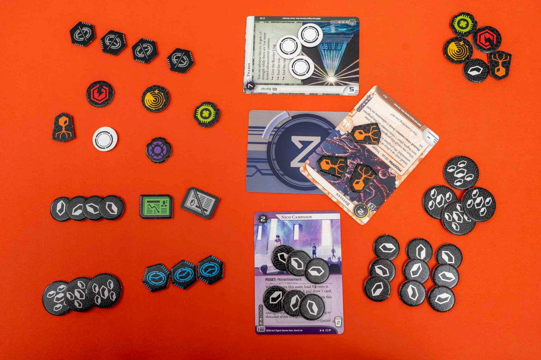 Netrunner: Tokens - Assorted round and rectangular cardboard tokens with various colors and symbols, arranged alongside cards featuring.