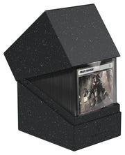 Ultimate Guard Return to Earth 133+ Boulder - Black - Black speckled triangular deck box with a clear window displaying a card inside.