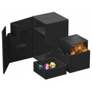 Ultimate Guard Flip N' Tray 100+ Monocolor - Black - Black flip-top storage box with separate compartments holding colorful gaming dice and card sleeves.
