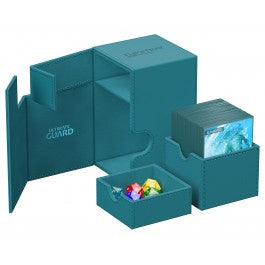 Ultimate Guard Flip N' Tray 100+ Monocolor - Petrol - Petrol blue rectangular card storage box with internal compartments and removable tray holding colorful dice.