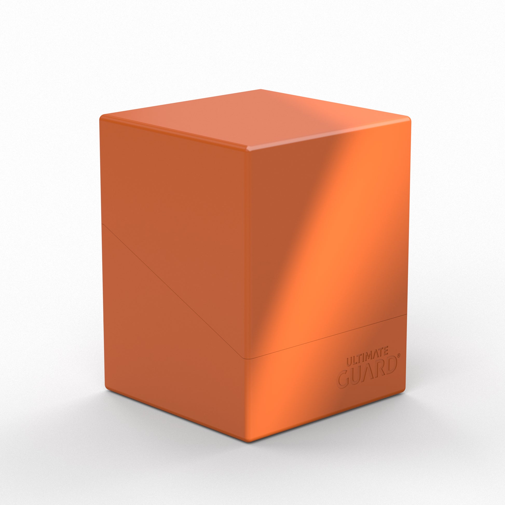Ultimate Guard Boulder 100+ Solid Color - Orange - Bright orange rectangular deck box with smooth matte finish and subtle embossed logo on the lower corner.