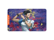 UniVersus TCG: Street Fighter 6 - Challenger Series Playmat - Chun-Li - Rectangular playmat with Chun-Li artwork, vibrant purple-blue background, and red UniVersus logo on left edge.