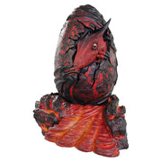 D&D Replicas of the Realms: Red Dragon Egg - Red dragon egg replica with textured cracked surface and black dragon claw wrapping around it, displayed on a fiery.