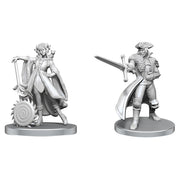Critical Role Unpainted Miniatures: Jester Lavorre & Fjord Stone - Unpainted gray resin miniatures of two fantasy characters, one with flowing robes and a mechanical arm, the other holding a.